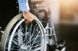 wheelchair user holding onto wheel